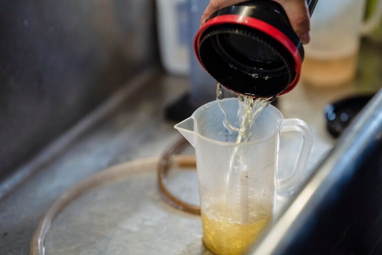 Detailed view of water being poured into a measuring cup, perfect for illustrating precision in liquid measurement.